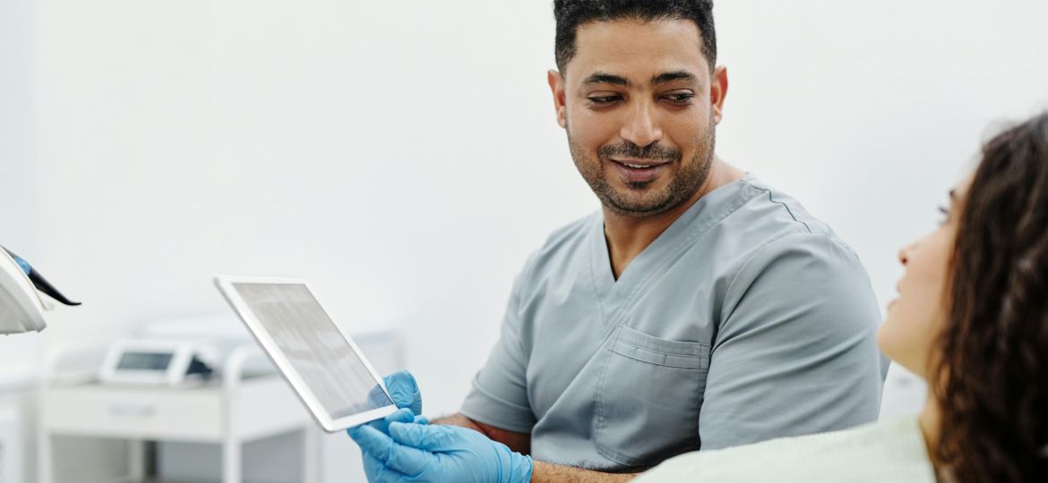 doctor holding a tablet to showcase issue to patient